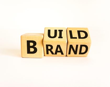 letter blocks spelling "build brand"