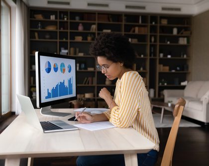 woman sitting at computer desks analyzing data