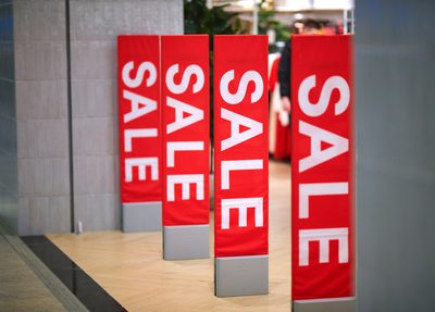 Red sale signs outside of outlet store