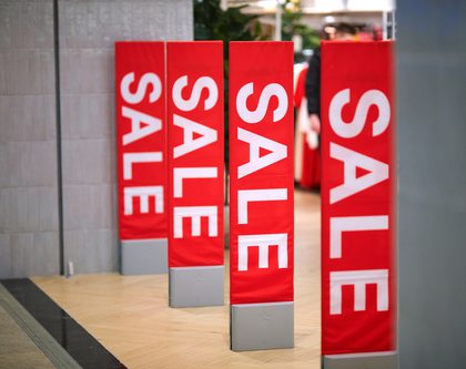 Red sale signs outside of outlet store