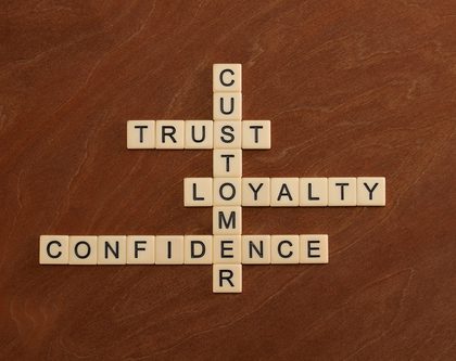 scrabble letters spelling out customer, trust, loyalty, confidence