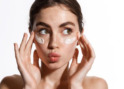 a girl with face cream on her face for skincare marketing
