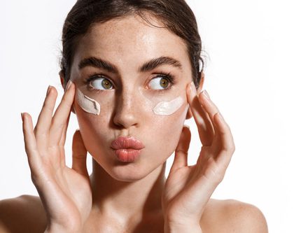 a girl with face cream on her face for skincare marketing