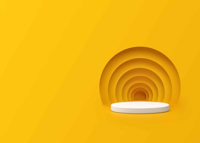A white round podium on a yellow background