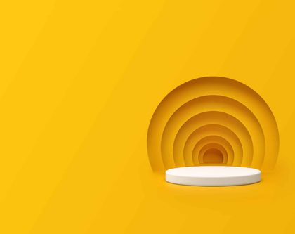 A white round podium on a yellow background