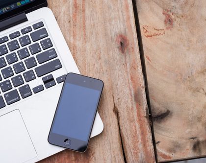 a mobile phone and a laptop on a desk