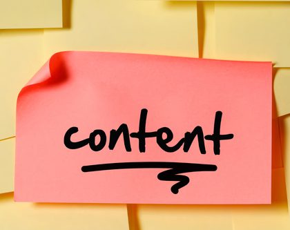 A pink sticky note with the word content