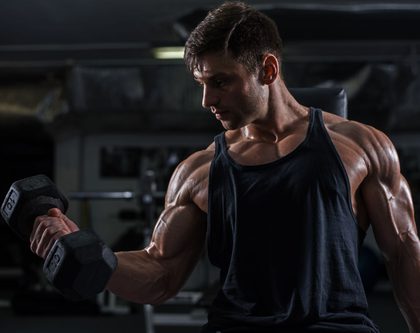 A PowerBlock man lifting weights in a gym