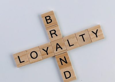 scrabble pieces spelling out "brand" and "loyalty"