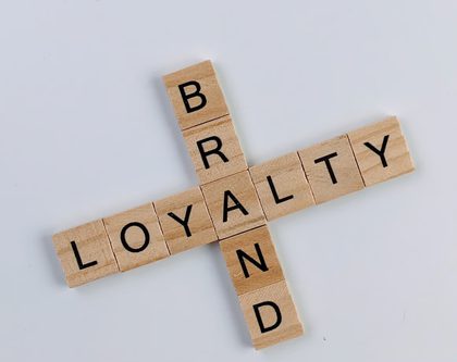 scrabble pieces spelling out "brand" and "loyalty"