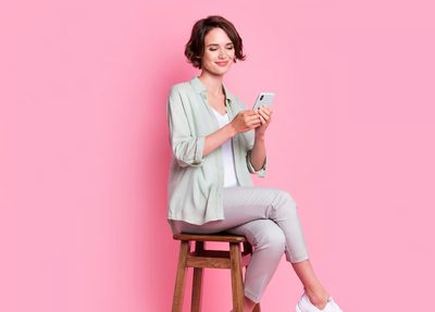 smiling woman sitting stool leaving a product review