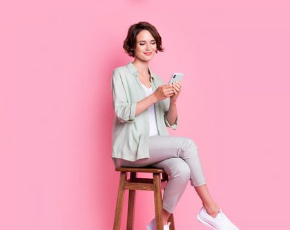 smiling woman sitting stool leaving a product review