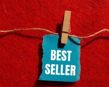 a clothing line with a piece of paper hanging that says "best seller"