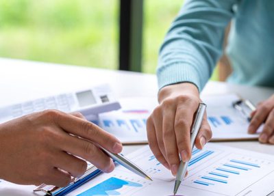 two people pointing at a report