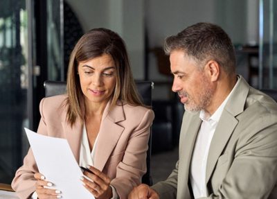 a man and a woman looking at a report
