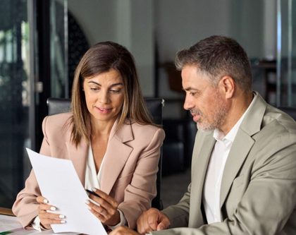 a man and a woman looking at a report