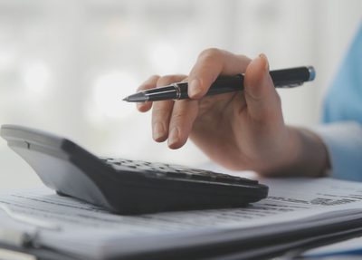 a close-up of a hand using a calculator