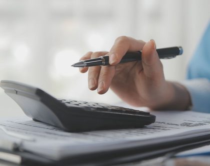 a close-up of a hand using a calculator