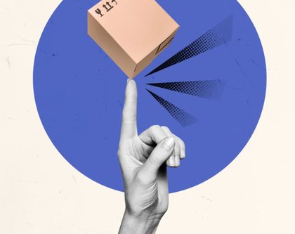 a hand pointing at a cardboard box