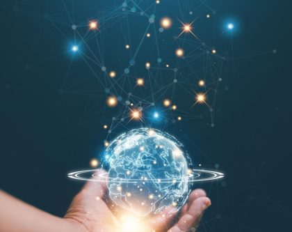 a hand holding a globe featuring network lines and dots