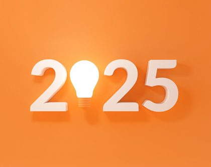 A bright light bulb on an orange backdrop for 2025 eCommerce trends
