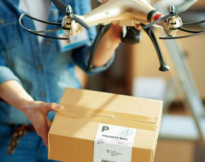 a woman displays a box with a drone
