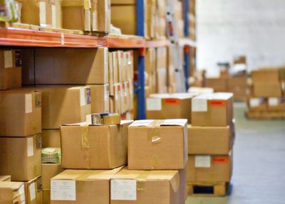 a warehouse filled with stacked boxes and organized shelves