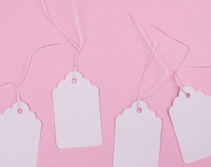 White paper tags on pink background