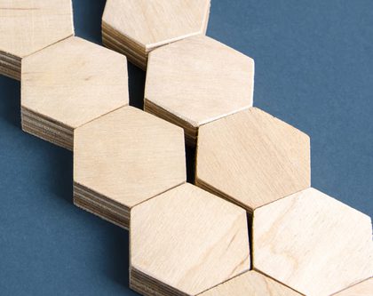 A close-up view of hexagon-shaped wooden tiles arranged in a geometric pattern.