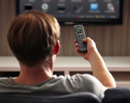 A man watching a smart TV