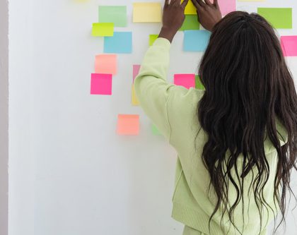 woman-putting-post-its-on-wall