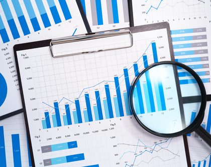 papers and spreadsheets with charts for Amazon Ads