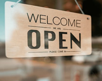 An open sign on a brand store door