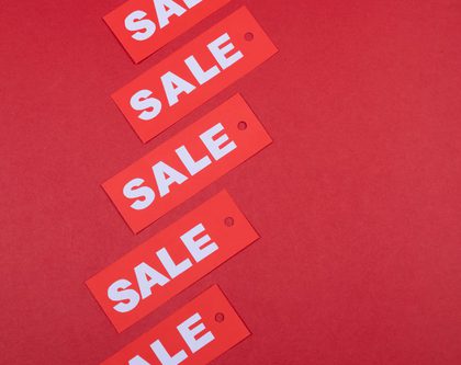 a collection of red sale tags on red background