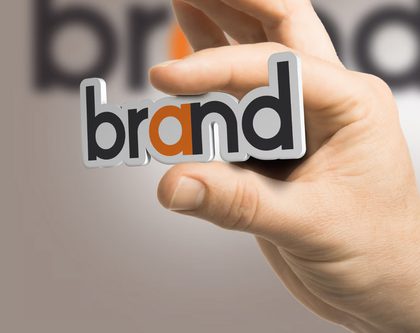 a hand holding brand sign