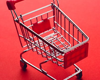 A shopping cart on a red background