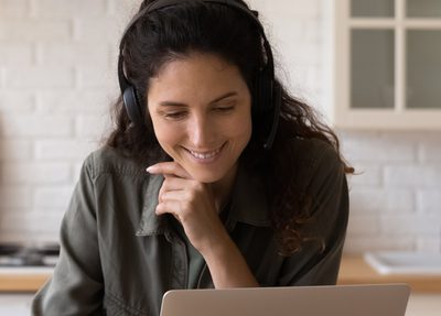 A woman watching a conference online
