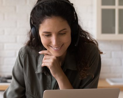 A woman watching a conference online