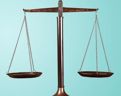 A justice scale standing on a desk