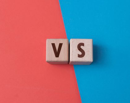 A red and blue fields with two wooden cubes with letters V and S for Walmart Brand Portal versus Amazon Brand Registry