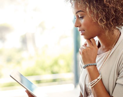 woman looking at ipad surprised