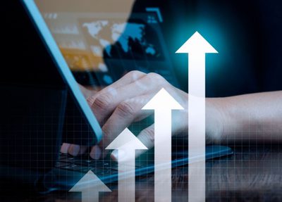 business man working on a laptop displaying a graph