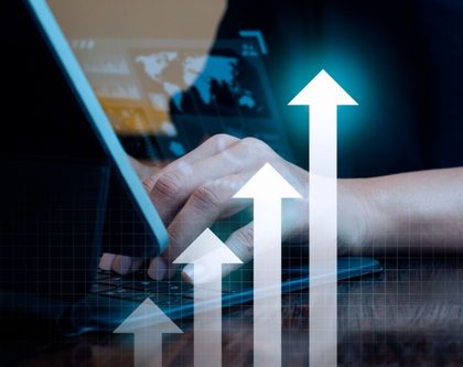 business man working on a laptop displaying a graph