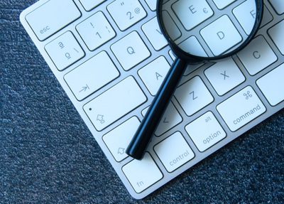 a magnifying glass resting on a keyboard