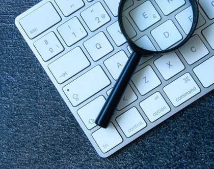 a magnifying glass resting on a keyboard