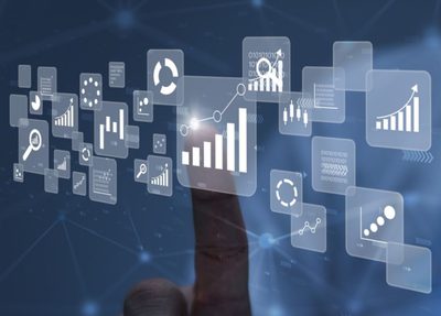 hand pointing to a graph within a dashboard surrounded by various data icons
