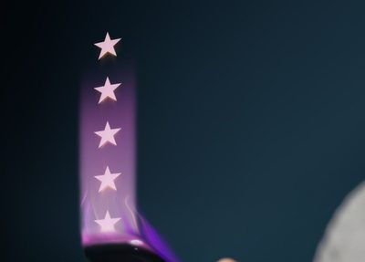a person holds a smartphone with five glowing stars emerging from the screen