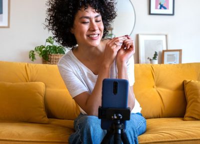an influencer setting up a tripod with a phone for video recording