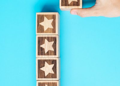 a person holds wooden blocks decorated with stars