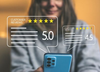 a woman holds a smartphone displaying five stars, symbolizing a high rating or positive feedback